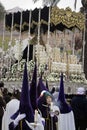 Detail penitent white holding a candle during Holy Week