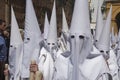 Detail penitent white holding a candle during Holy Week