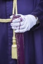 Detail penitent white holding a candle during Holy Week