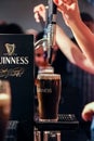 Detail of peopleÃÂ´s hands pouring a pint of guinness at the guinness counter in Guinness Storehouse Brewery Royalty Free Stock Photo