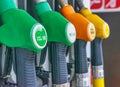 Detail of a petrol pump in a petrol station. Close up on fuel nozzle with green, orange and yellow colors in oil dispenser with Royalty Free Stock Photo