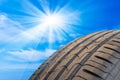 Detail photo of a car tire profile with sky in background Royalty Free Stock Photo