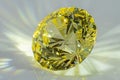Detail photo focus stacking of a self-cut Cubic Zirconia with Lemon color and Tour Top cut, placed on a white acrylic glass surf