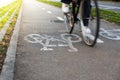 Detail photograph of the Barcelona bike lane symbol with a cyclist in movement. Blurred bicycle