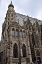 Detail, photographed from the side, of the beautiful Vienna cathedral. The Gothic guglielmo are stretched out in the blue sky.