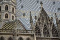 Detail, photographed from the side, of the beautiful Vienna cathedral. The Gothic spiers have the beautiful roof tiles in the back