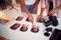 Detail Of Photographer With Female Client Editing Images From Portrait Photo Shoot In Studio