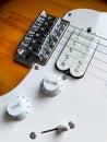 Detail of the pickups of an electric guitar and the volume and tone knobs, selective focus