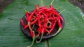 Detail of a pile of dark red chilies on a mortar with a banana leaf base