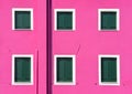 Detail with a pink colorful house window with green painted wooden shutters in Burano, Italy Royalty Free Stock Photo