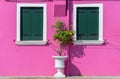 Detail with a pink colorful house window with green painted wooden shutters in Burano, Italy Royalty Free Stock Photo