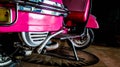 Detail of pink scooter with chromed metallic fender