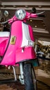 Detail of pink scooter with chromed metallic fender