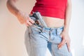 Detail of pistol holding in jeans waist ofyoung woman Royalty Free Stock Photo