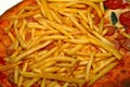 detail of pizza with french fries and wurstel Royalty Free Stock Photo