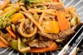 detail of a plate of yakisoba with a pair of chopsticks