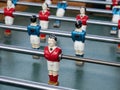 Some players on a Mini football game table in close up view