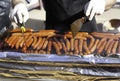Hands cooking sausage on the grill Royalty Free Stock Photo
