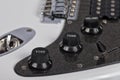 Detail of the potentiometers of a white electric guitar Royalty Free Stock Photo