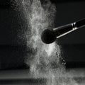 Detail of a powder brush with white loose powder