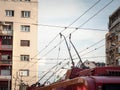 Detail of the power pole and pantograph of a trolleybus connecting the vehicle to the electrical cable line, the overhead cable