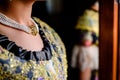 Detail of a pretty woman dressed in the traditional Valencian Fallera dress with her neck decorated with a luxurious necklace Royalty Free Stock Photo