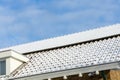 Detail of Private solar panels with snow on a detached bungalow family house on the roof in the winter. Royalty Free Stock Photo