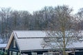 Detail of Private solar panels with snow on a detached bungalow family house on the roof in the winter. Royalty Free Stock Photo