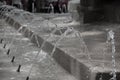 Detail of public fountain with many small water jets Royalty Free Stock Photo