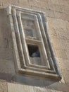 Window with inside a pigeon in the mosque of Alladin to Konya in Turkey.
