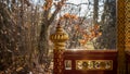 Detail of red and golden Thai Pavilion architecture. Pavillon Thailandais with trees in autumn. Lausanne, Switzerland Royalty Free Stock Photo