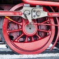 Detail of red iron drive wheel of old steam locomotive Royalty Free Stock Photo