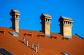 Detail of red roof with chimnies at blue sky Royalty Free Stock Photo