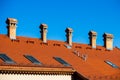 Detail of red roof with chimnies at blue sky Royalty Free Stock Photo