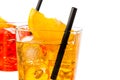 Detail of red and yellow cocktail with orange slice on top and straw isolated on white background Royalty Free Stock Photo