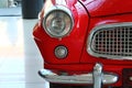 Detail of right headlight and bumper of veteran Czechoslovak car Skoda Felicia from year 1961, red colour.