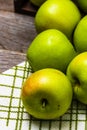 Detail on ripe green apples on wooden table