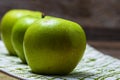 Detail on ripe green apples on wooden table