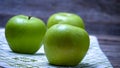 Detail on ripe green apples on wooden table