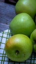 Detail on ripe green apples on wooden table