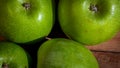 Detail on ripe green apples on wooden table