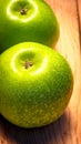 Detail on ripe green apples on wooden table