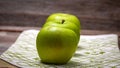 Detail on ripe green apples on wooden table