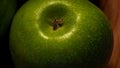 Detail on ripe green apples on wooden table