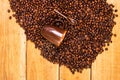 Detail of roasted coffee beans and coffee cup on wooden background, top view, copy space for text, close up coffee photo Royalty Free Stock Photo