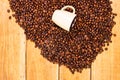 Detail of roasted coffee beans and coffee cup on wooden background, top view, copy space for text, close up coffee photo Royalty Free Stock Photo