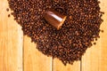 Detail of roasted coffee beans and coffee cup on wooden background, top view, copy space for text, close up coffee photo Royalty Free Stock Photo