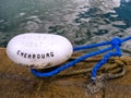 Detail of rope end anchored into sandstone rock for mooring boats and ships