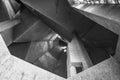 Detail of rough raw concrete ceiling with abstract geometric patterns of brutalist architecture.