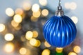 Detail of round blue bauble on blurred background with bokeh